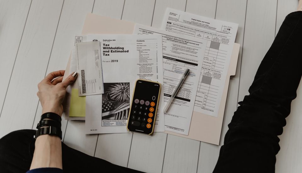 Household papers and a calculator on the floor