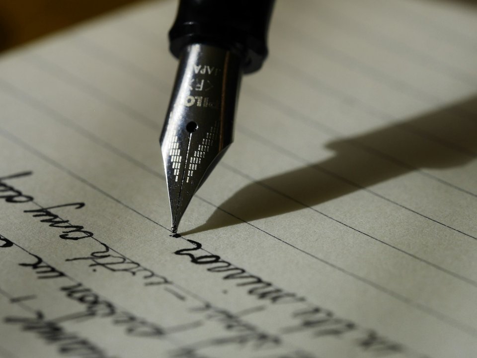 Fountain pen writing on warm lined paper