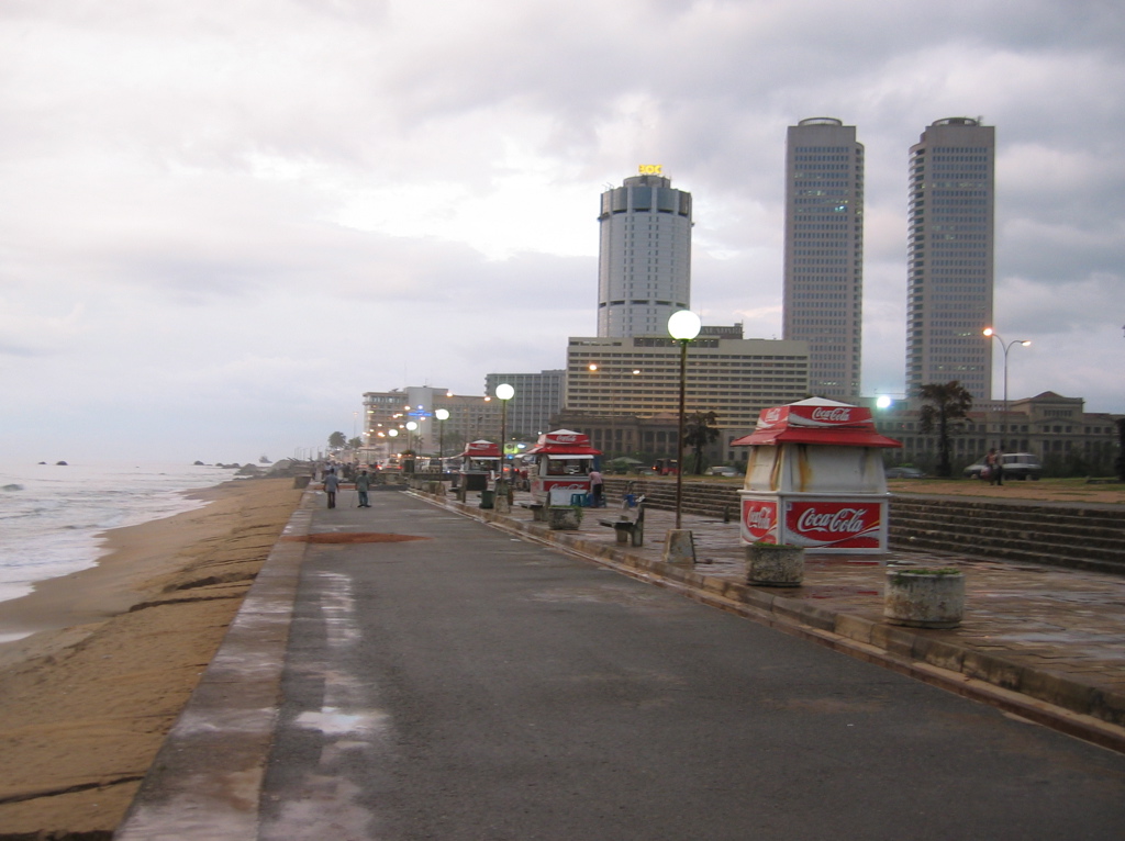 Galle Face beach and promenade - surf on one side, food kiosks and the Fort towers ahead